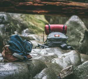two gray and orange backpacks on gray rocks at daytime